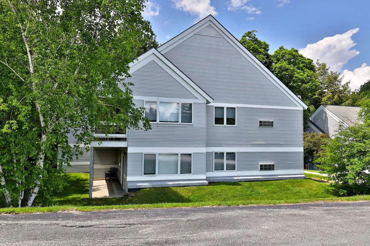A modern building framed by greenery, with large windows that blur the line between indoors and outdoors. The space is ideal for outdoor gatherings, relaxing with nature, and enjoying sunset views from the porch.
